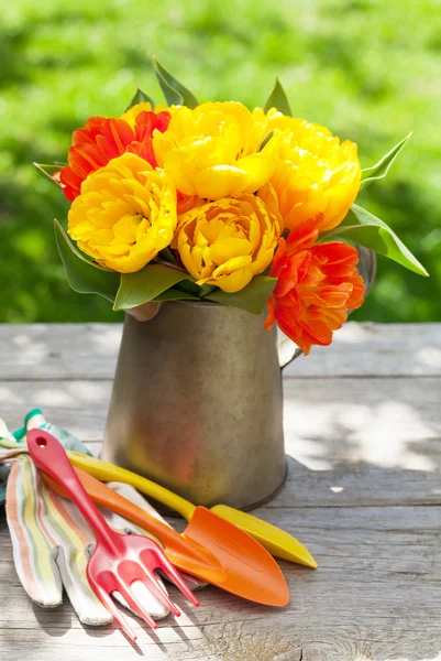 Colorful tulips and garden tools — Stock Photo, Image