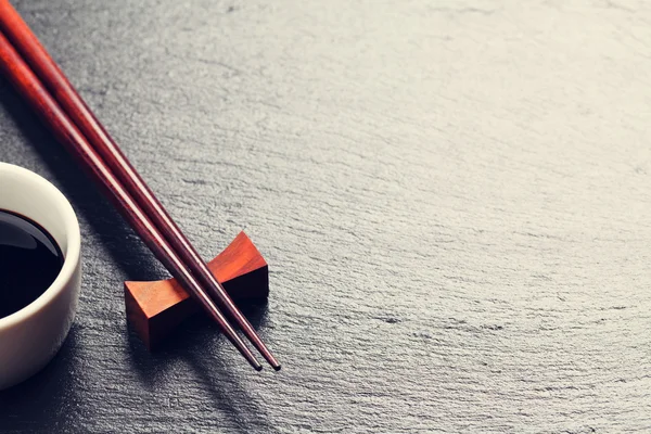 Japanese sushi chopsticks and soy sauce bowl — Stock Photo, Image