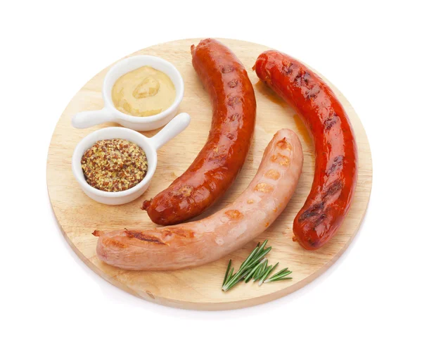 Grilled sausages with condiments — Stock Photo, Image