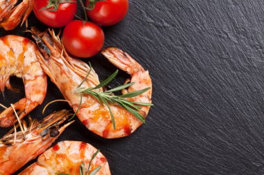 Grilled shrimps on stone plate clipart