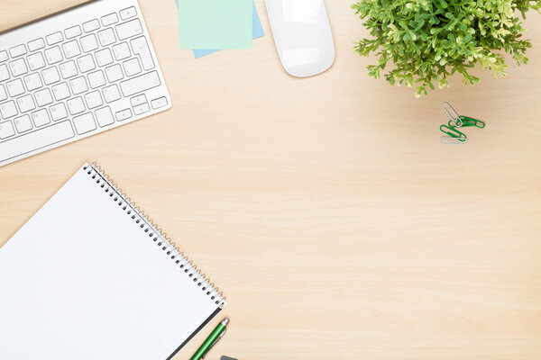 Office table with notepad, computer