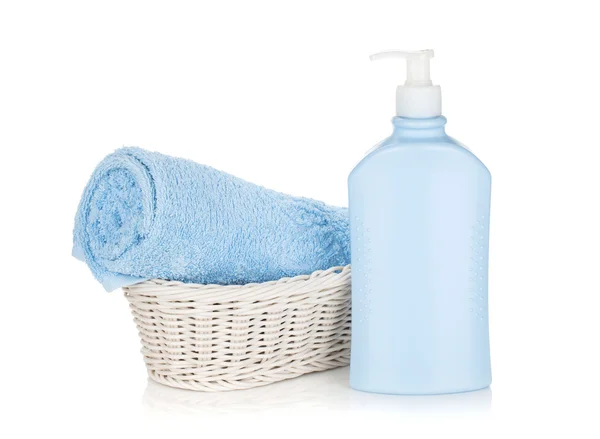 Shampoo bottle and blue towel — Stock Photo, Image