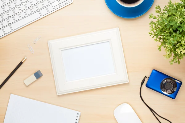 Photo frame on office table with computer — Stok fotoğraf