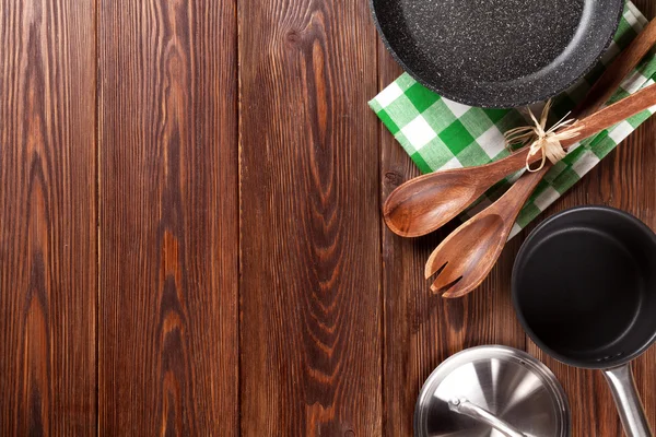 Cooking utensils on wooden table — Stock Photo, Image