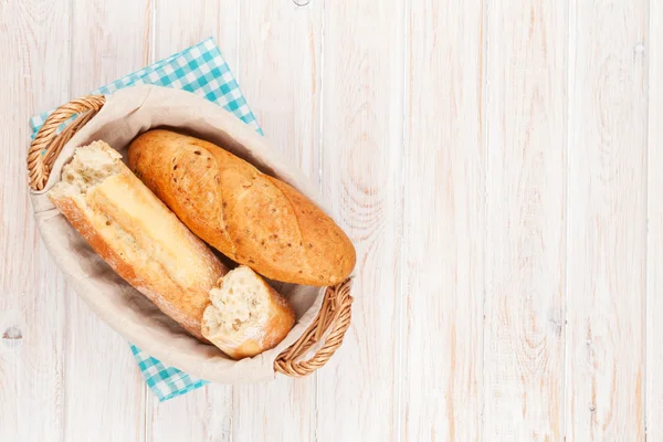 Fresh french bread in basket — Stock Photo, Image