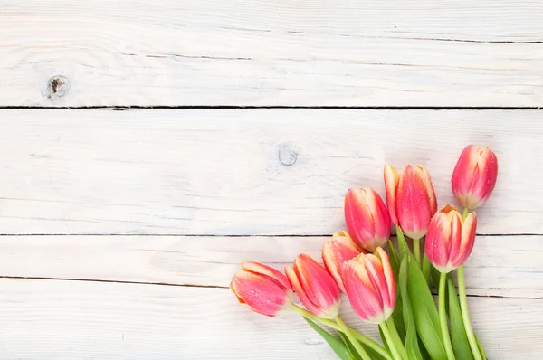 Colorful tulips on wooden table — Stock Photo, Image