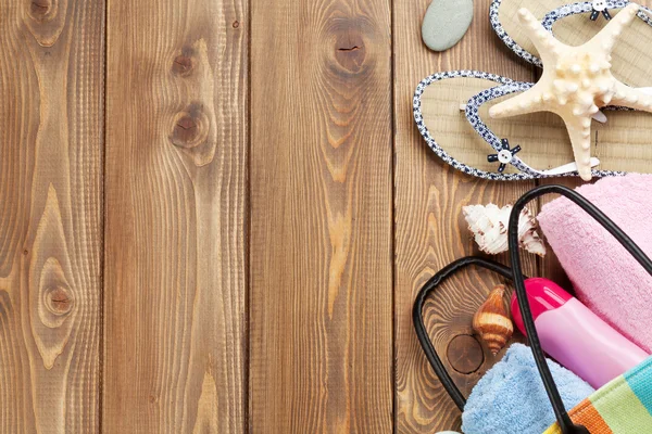 Travel and vacation items on wooden table