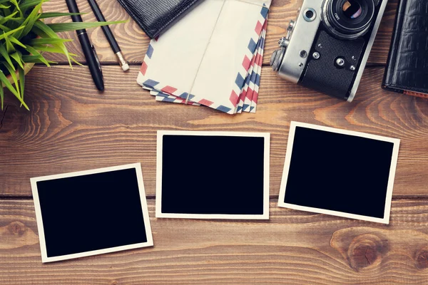 Photo frames, camera and supplies on table Royalty Free Stock Photos