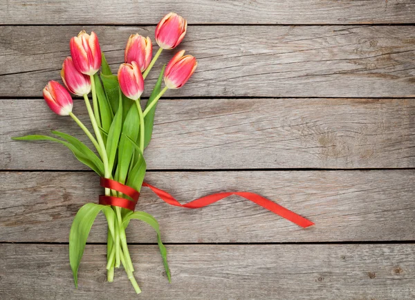 Colorful tulips on wooden table — Stock Photo, Image