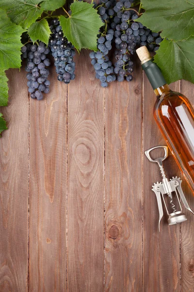 Uva roja, botella de vino y sacacorchos —  Fotos de Stock
