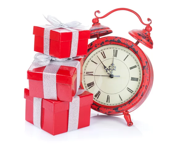 Christmas clock and three gift boxes — Stock Photo, Image