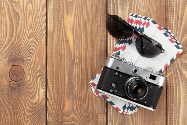 Camera, letters and sunglasses on office desk — Stock Photo, Image