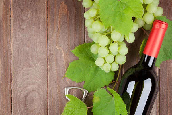 Bunch of grapes, red wine bottle Stock Photo