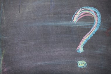 Colorful chalk question mark on blackboard