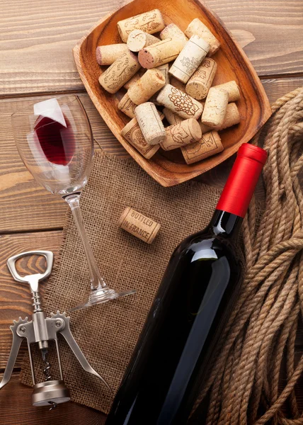 Red wine bottle, wine glass, bowl with corks and corkscrew — Stock Photo, Image
