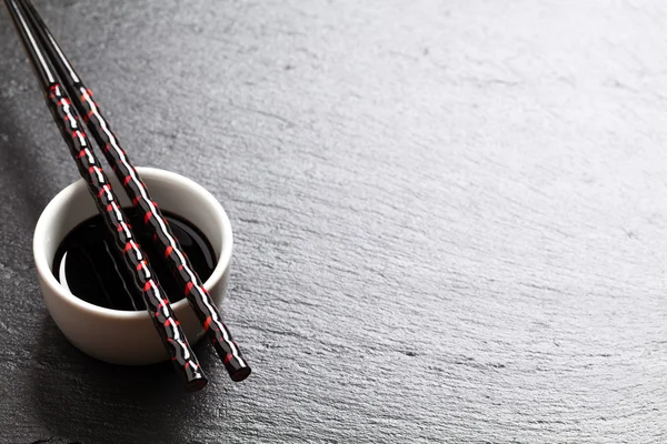 Sushi chopsticks with soy sauce bowl — Stock Photo, Image