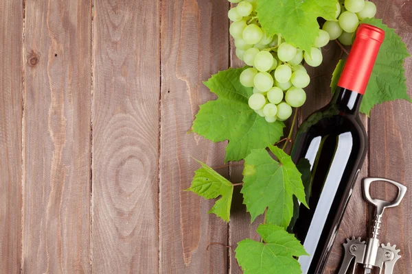 Bunch of grapes, wine bottle and corkscrew — Stock Photo, Image