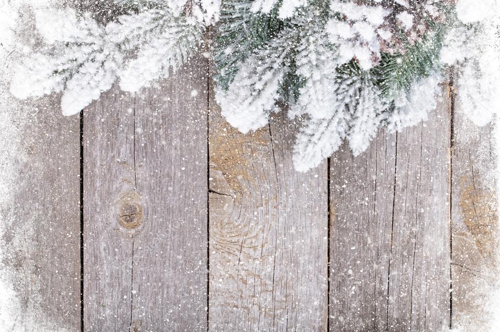 Old wood texture with snow and firtree