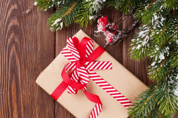 Christmas gift box and snow fir tree — Stock Photo, Image