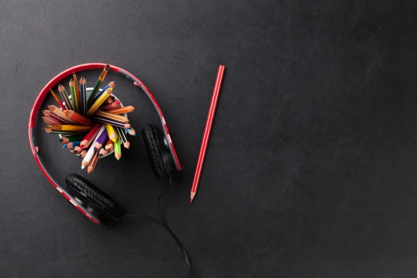 Office leather desk with pencils and headphones — Stock Photo, Image