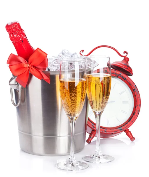 Champagne glasses, bottle in cooler and clock — Stock Photo, Image