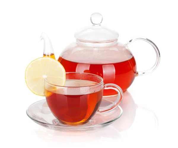 Glass teapot and cup of black tea with lemon slice — Stock Photo, Image