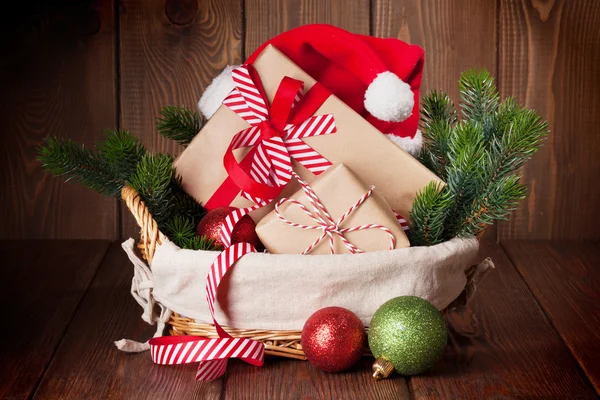 Christmas gifts and tree branch — Stock Photo, Image