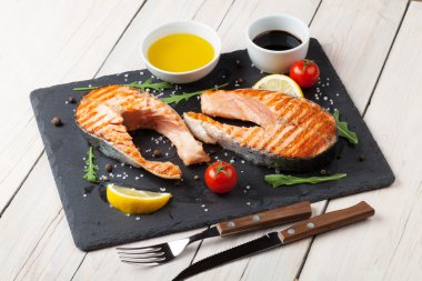 Grilled salmon, salad and condiments clipart