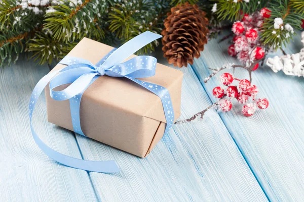 Christmas gift box and tree branch — Stock Photo, Image