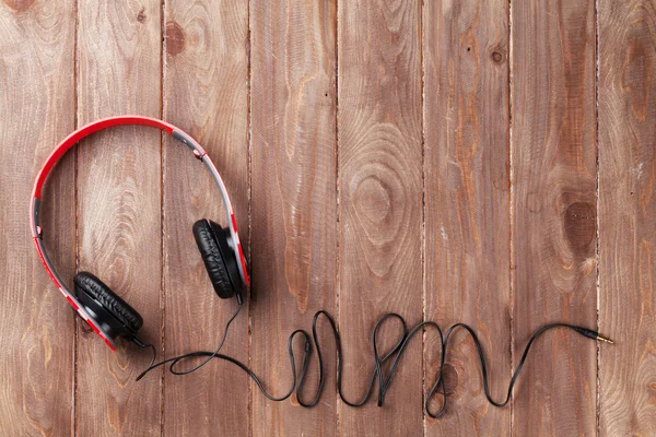 Headphones on wooden desk table — Stock Photo, Image