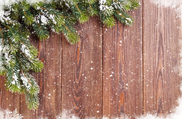 Christmas wooden background with snow fir tree — Stock Photo, Image