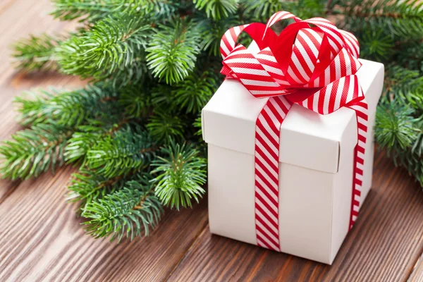 Christmas gift box and fir tree branch — Stock Photo, Image