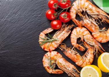 Grilled shrimps on stone plate clipart