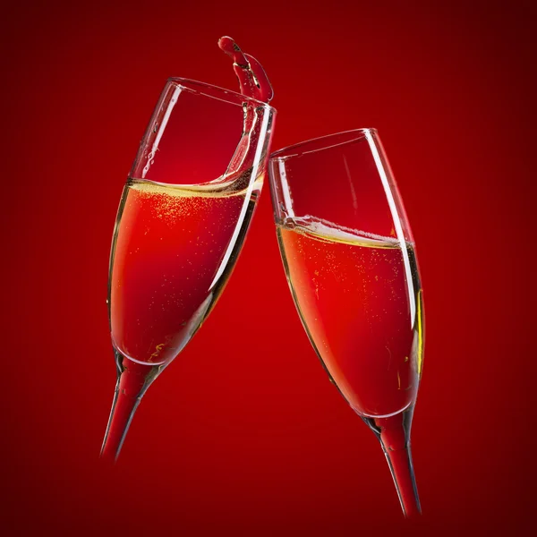 Two champagne glasses on red — Stock Photo, Image