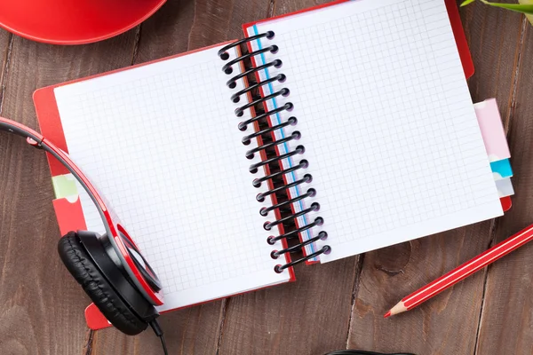 Desk with notepad, coffee and headphones — Stock Photo, Image