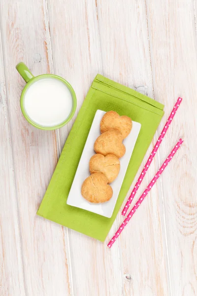 Cup of milk, heart shaped cookies — Stock Photo, Image