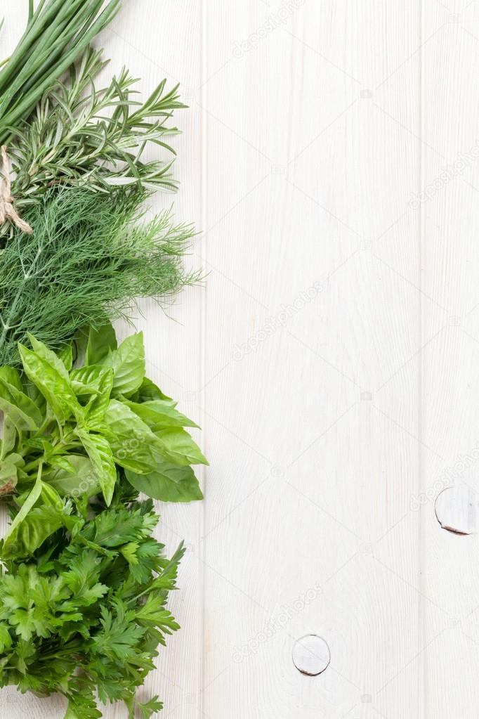 Fresh garden herbs on wooden table