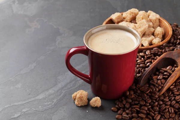 Coffee cup, beans and sugar on table — Stock Photo, Image