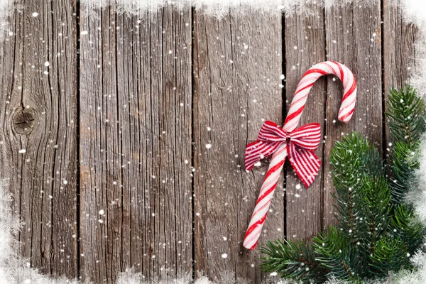 Christmas candy cane on wooden table — Stock Photo, Image