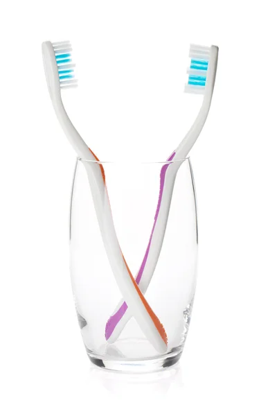 Two toothbrushes in a glass — Stock Photo, Image