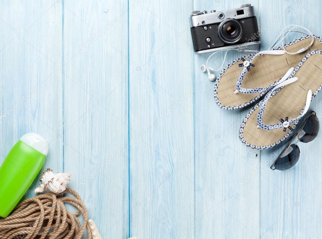 Travel and vacation items on wooden table