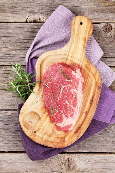 Raw beef steak with spices and herbs — Stock Photo, Image
