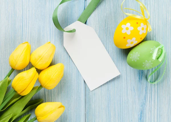 Easter eggs, tulips and blank tag — Stock Photo, Image