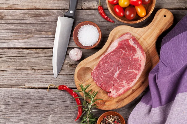 Raw beef steak with spices and herbs — Stock Photo, Image