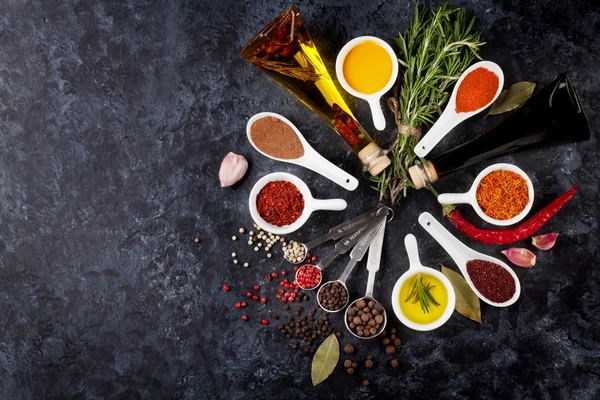 Herbs, condiments, spices and bottles of oil — Stock Photo, Image