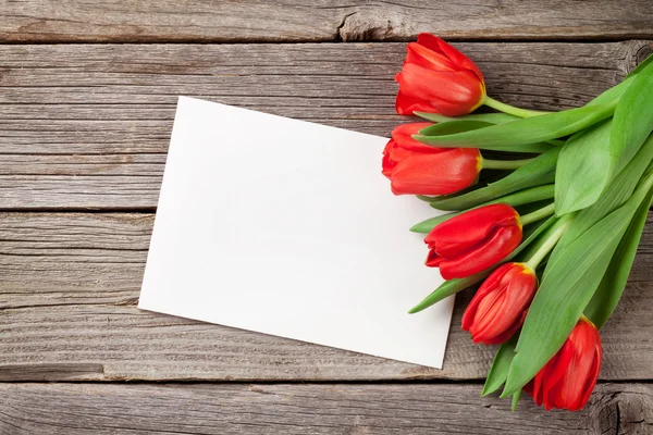 Red tulips and greeting card — Stock Photo, Image