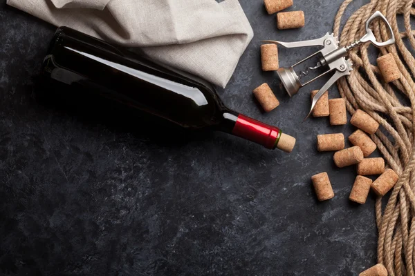 Red wine bottle, corks and corkscrew — Stock Photo, Image