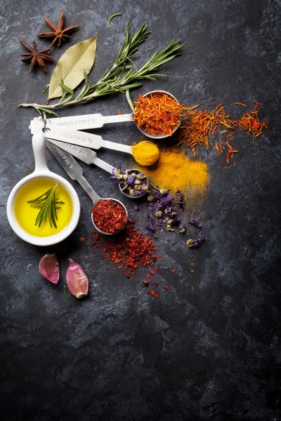 Herbs and spices over black stone — Stock Photo, Image
