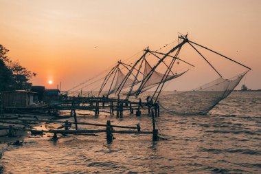 Chinese fishing net at sunrise in Cochin, Kerala, India clipart