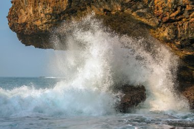 Big wave crashing into the rocks
